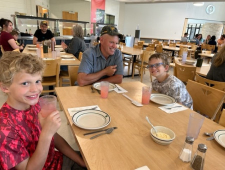 A family enjoying dinner together in the dining hall.