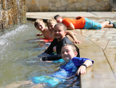 Youth playing in the water at camp.