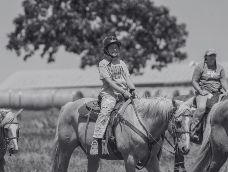 Campers riding horses.